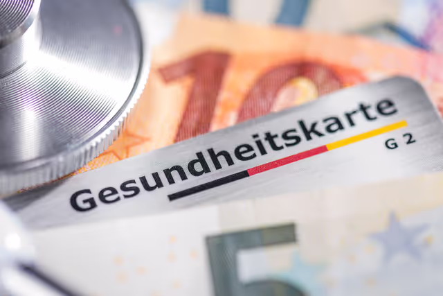 A German Krankenkassenkarte surrounded by Euro Notes